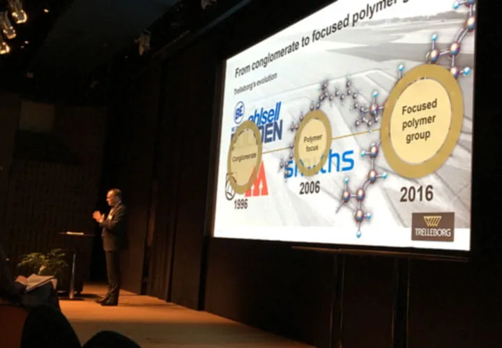 Peter Nilsson on the stage holding a presentaton