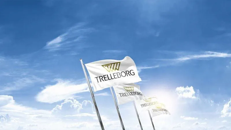 Trelleborg flags waving against a blue sky, representing the company headquarters