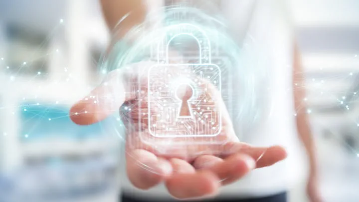 Hand holding a glowing digital padlock icon representing security and data protection